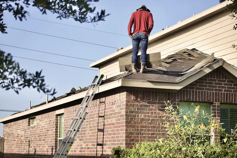 Professional roofer working on a residential roof in Sycamore Springs